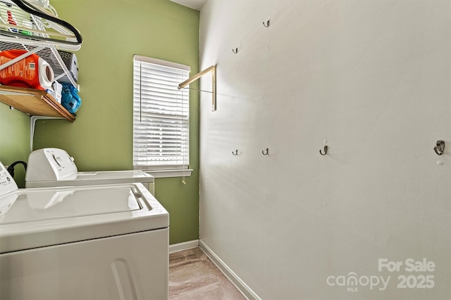 laundry room featuring laundry area, washer and clothes dryer, and baseboards