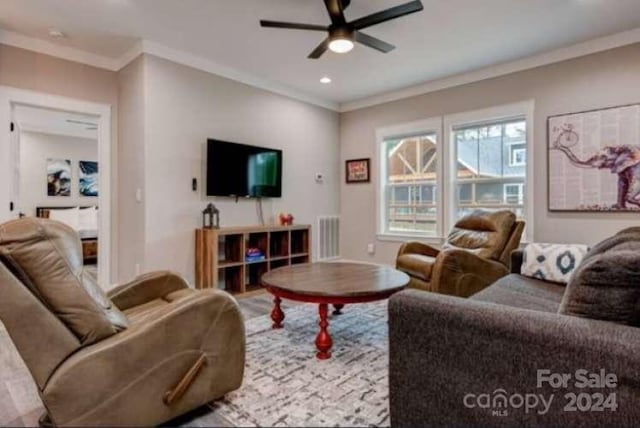 living room featuring ceiling fan and crown molding