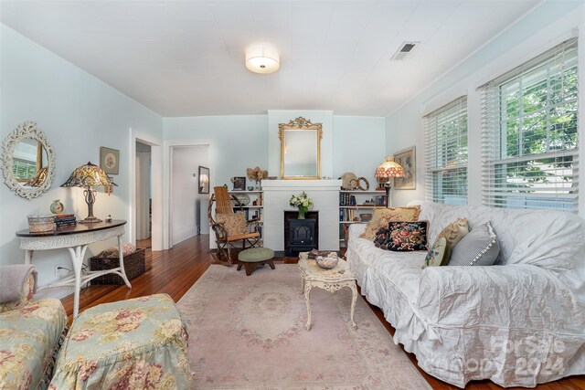 living room with hardwood / wood-style flooring and a wood stove