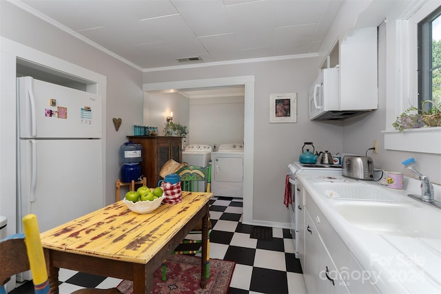 404 Montreat Rd, Black Mountain, NC 28711 - kitchen with independent washer and dryer, dark floors, visible vents, freestanding refrigerator, and white cabinets