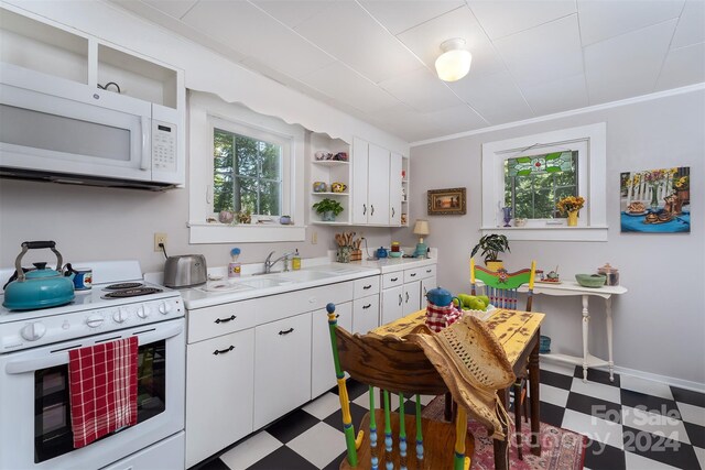 kitchen featuring light tile patterned floors, sink, white appliances, and white cabinetry