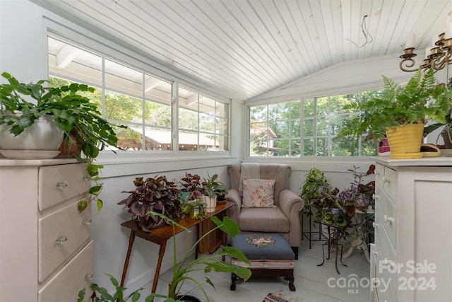 sunroom featuring vaulted ceiling and wood ceiling