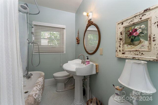 full bathroom featuring sink, toilet, separate shower and tub, and tile patterned floors