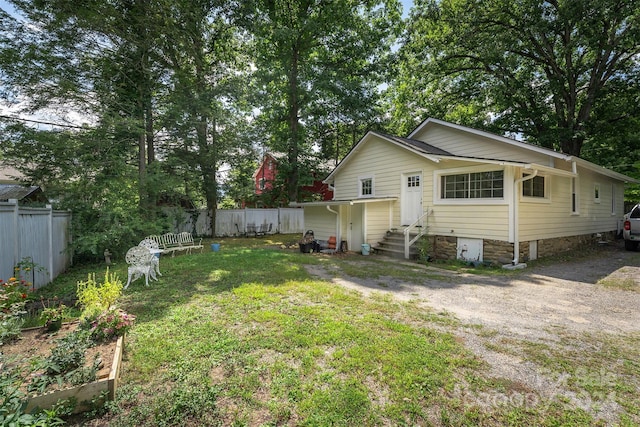 404 Montreat Rd, Black Mountain, NC 28711 - exterior space with entry steps, a vegetable garden, fence, and a yard