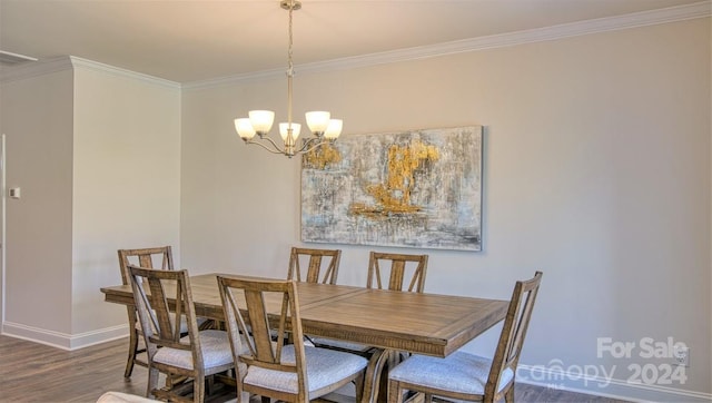 dining room with a notable chandelier, ornamental molding, and wood-type flooring