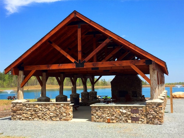 surrounding community with a water view and a gazebo