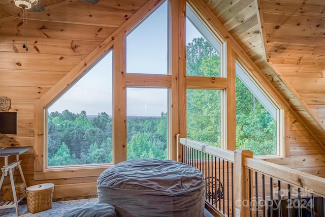 interior space with wood ceiling, vaulted ceiling, and wood walls