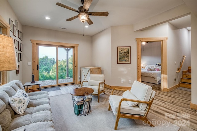 living room with ceiling fan and light wood-type flooring