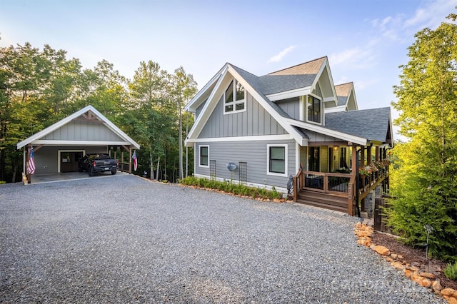 view of side of property featuring covered porch and a carport