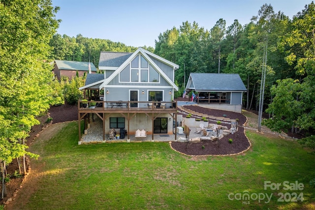 back of property featuring a patio area and a lawn