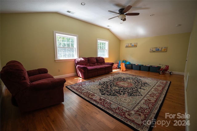 living room featuring hardwood / wood-style flooring, ceiling fan, and lofted ceiling