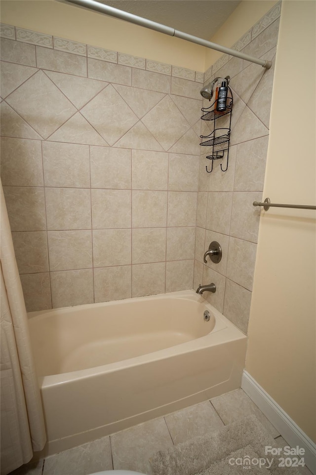 bathroom with shower / tub combo and tile patterned flooring