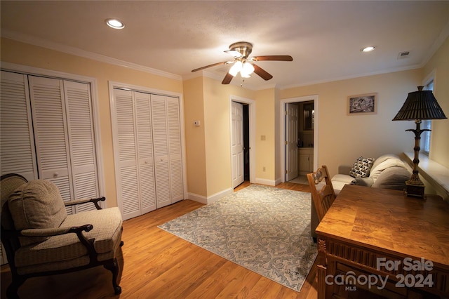 office area with crown molding, ceiling fan, and light wood-type flooring