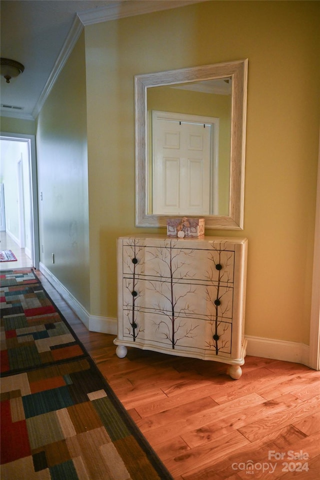 hallway featuring crown molding and hardwood / wood-style flooring