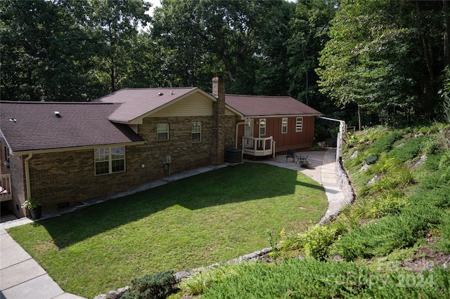 exterior space with central AC and a front lawn