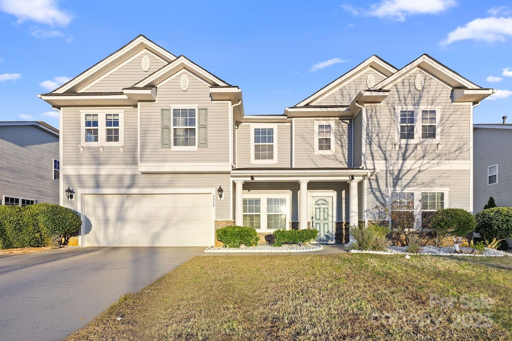 view of front facade featuring a garage and a front lawn