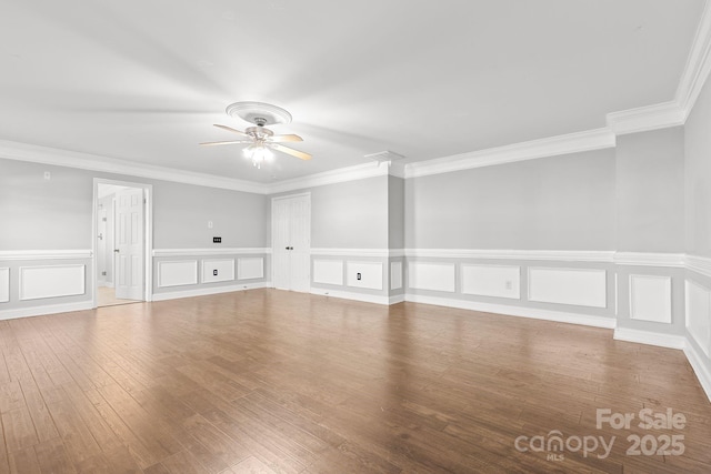 empty room featuring ceiling fan, ornamental molding, and hardwood / wood-style floors