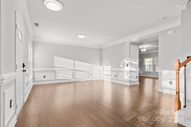 unfurnished living room with ceiling fan, hardwood / wood-style floors, and crown molding