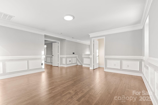 interior space featuring crown molding and hardwood / wood-style floors