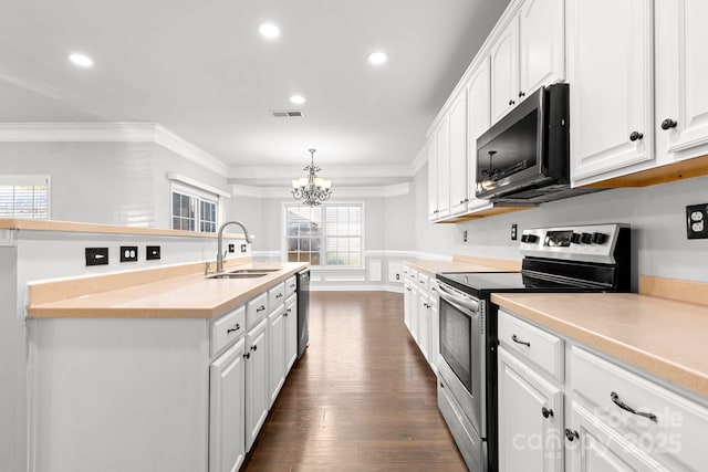 kitchen featuring white cabinets, hanging light fixtures, appliances with stainless steel finishes, and sink