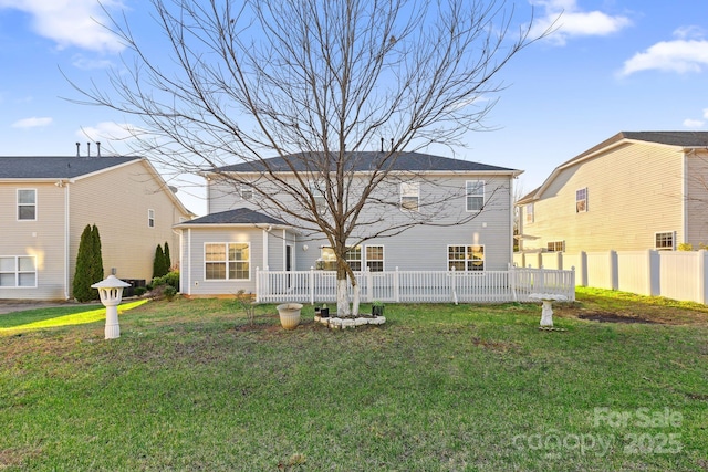 rear view of house featuring a yard