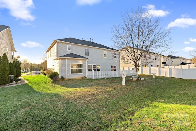 rear view of house with a yard