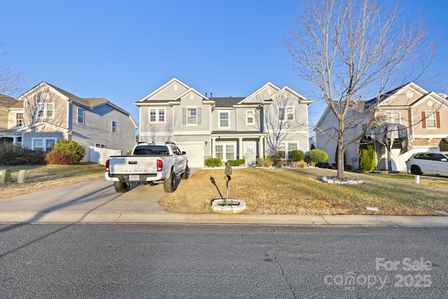 view of front facade featuring a front yard and a garage