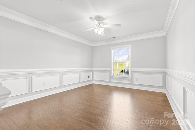 empty room featuring ceiling fan, crown molding, and hardwood / wood-style flooring