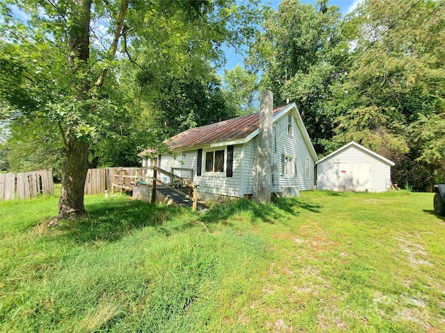 exterior space with an outbuilding and a lawn