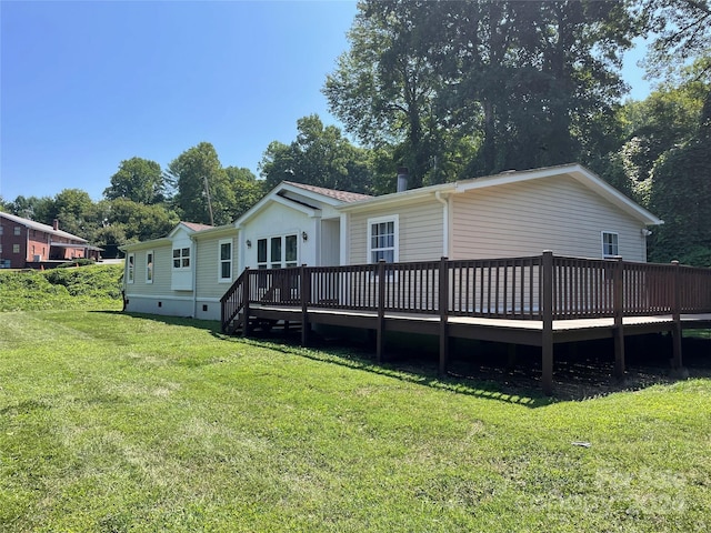 rear view of house with crawl space, a lawn, and a wooden deck