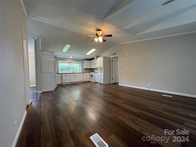 unfurnished living room featuring visible vents, a ceiling fan, a sink, dark wood-style floors, and vaulted ceiling