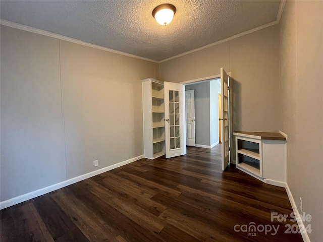 unfurnished room featuring baseboards, a textured ceiling, ornamental molding, and dark wood-style flooring