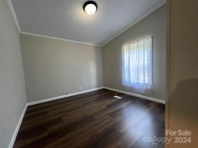 unfurnished room with lofted ceiling, a textured ceiling, dark wood finished floors, crown molding, and baseboards