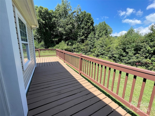 wooden deck featuring a yard