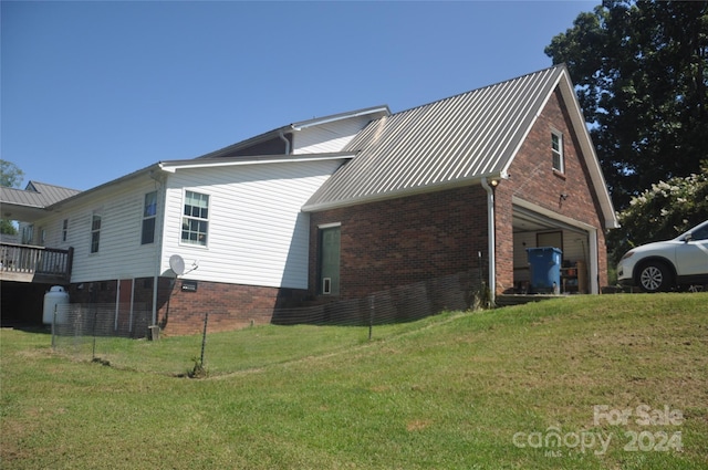 view of side of home with a yard