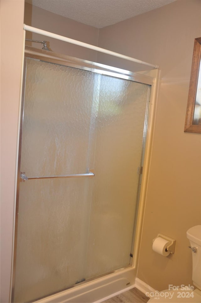 120 Old Belwood Rd, Lawndale, NC 28090 - bathroom featuring toilet, a shower stall, and a textured ceiling