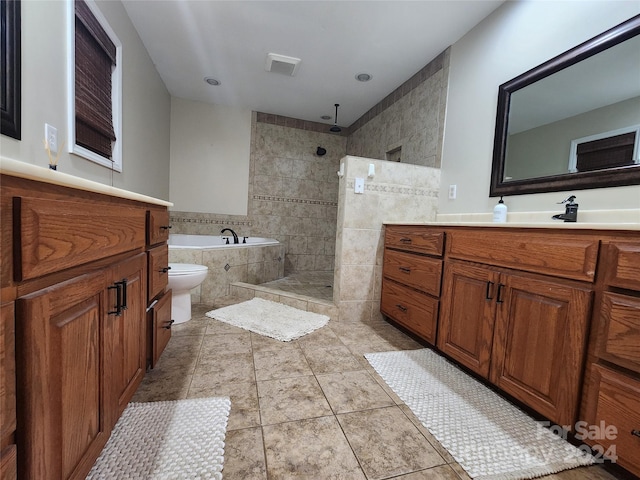 full bathroom featuring toilet, shower with separate bathtub, vanity, and tile patterned floors