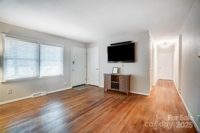 unfurnished living room featuring light wood-type flooring