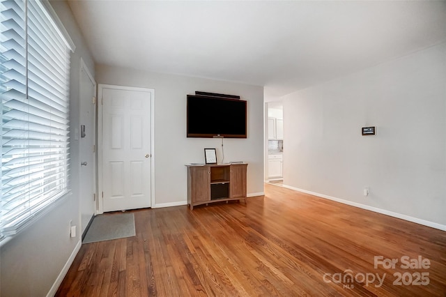 unfurnished living room with wood-type flooring