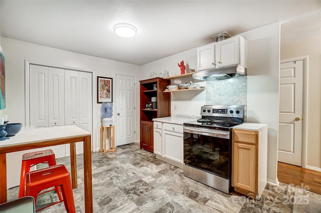 kitchen with decorative backsplash, electric stove, and white cabinetry