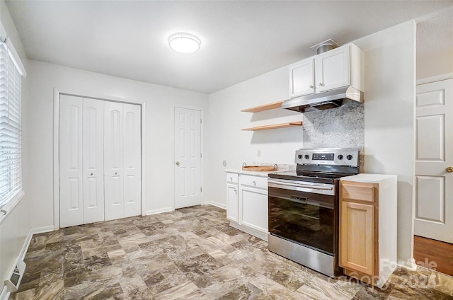 kitchen with white cabinets, stainless steel electric range, a healthy amount of sunlight, and tasteful backsplash