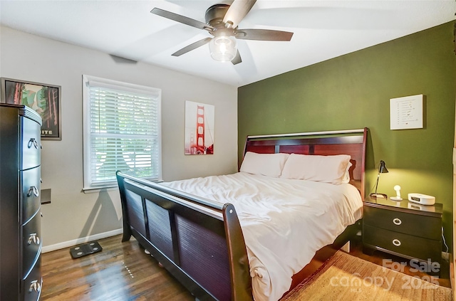 bedroom featuring ceiling fan, fridge, and dark wood-type flooring