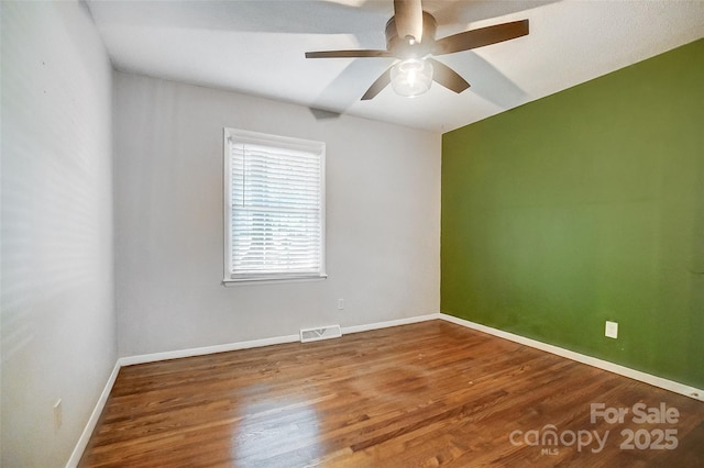 empty room with ceiling fan and hardwood / wood-style flooring