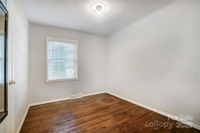 empty room featuring dark hardwood / wood-style floors