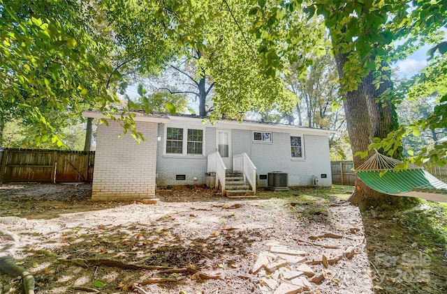 back of property featuring central AC