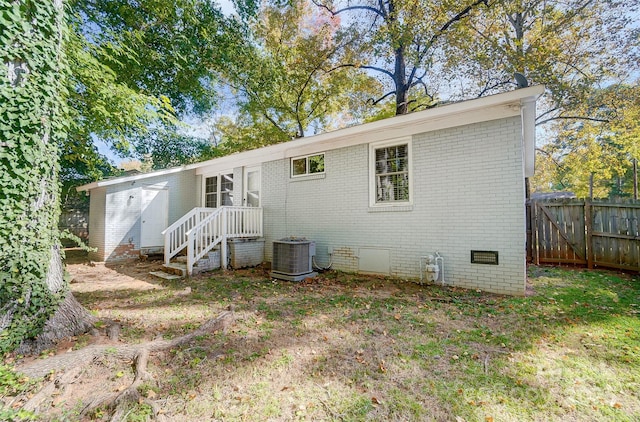 back of house featuring central AC unit