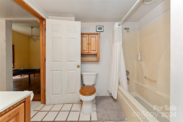 full bath featuring ceiling fan, vanity, toilet, tile patterned floors, and shower / bath combo with shower curtain