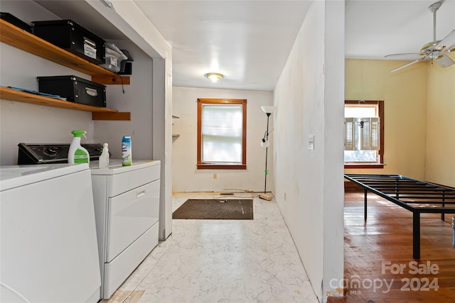 washroom with laundry area, washer and clothes dryer, ceiling fan, and a healthy amount of sunlight
