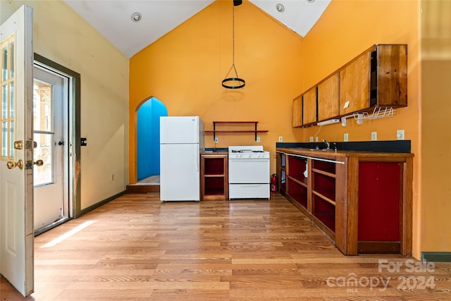 kitchen featuring brown cabinets, open shelves, light wood finished floors, white appliances, and high vaulted ceiling