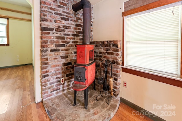 details featuring hardwood / wood-style flooring and a wood stove